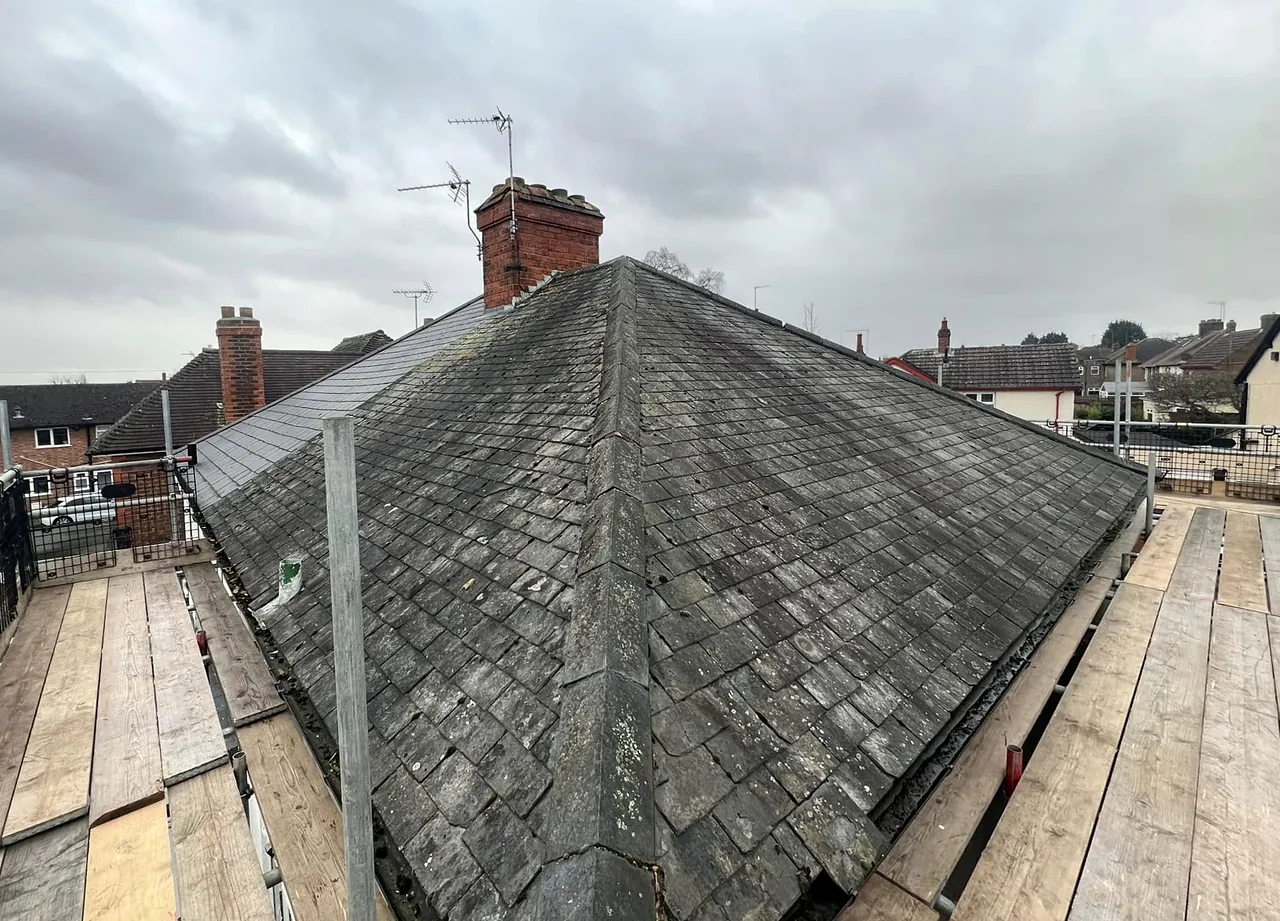 The roof in Kettering before: the old weathered covering, from the scaffold